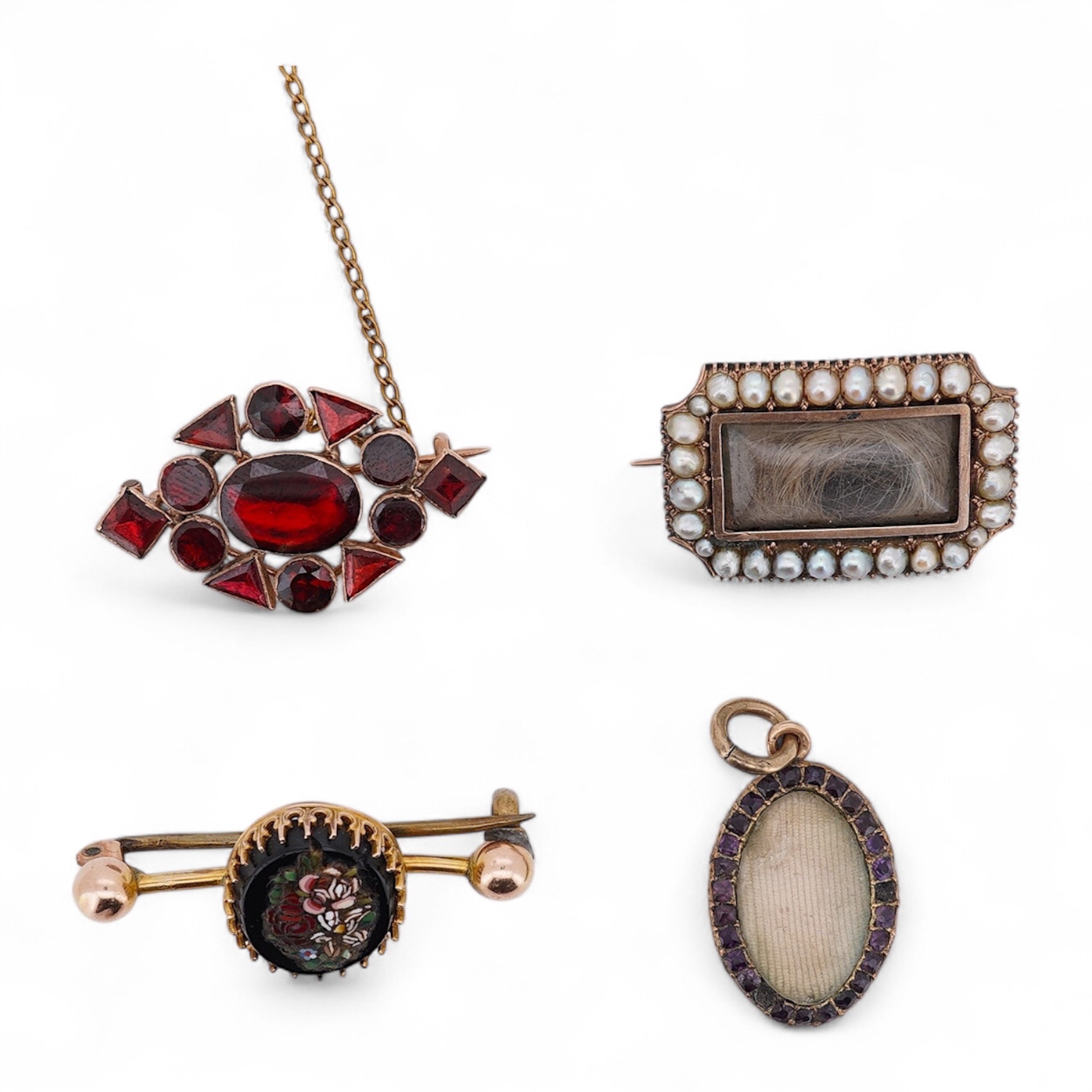 Three assorted Victorian brooches including a 9ct and garnet cluster by Murrle Bennett & Co, 27mm, a micro mosaic bar brooch and a yellow metal and split pearl mourning brooch, together with a gem set oval pendant. Condi